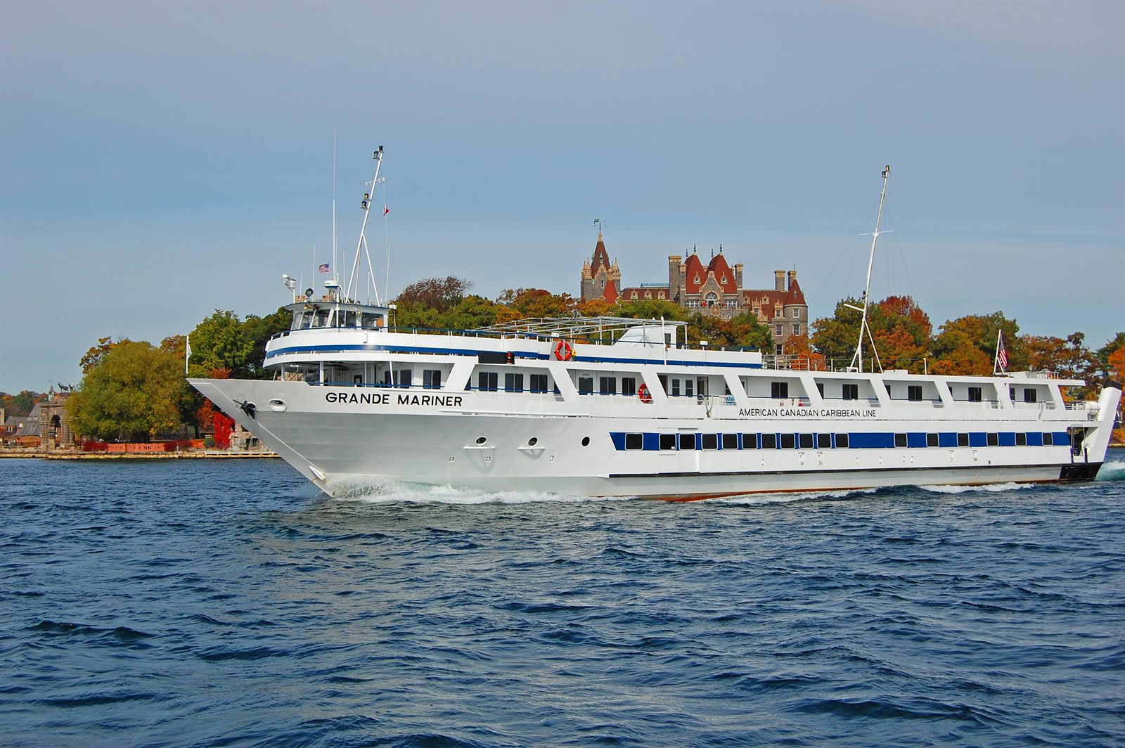 Small cruise ship passing a castle in the Thousand Islands, New York